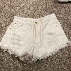 White ripped jean shorts